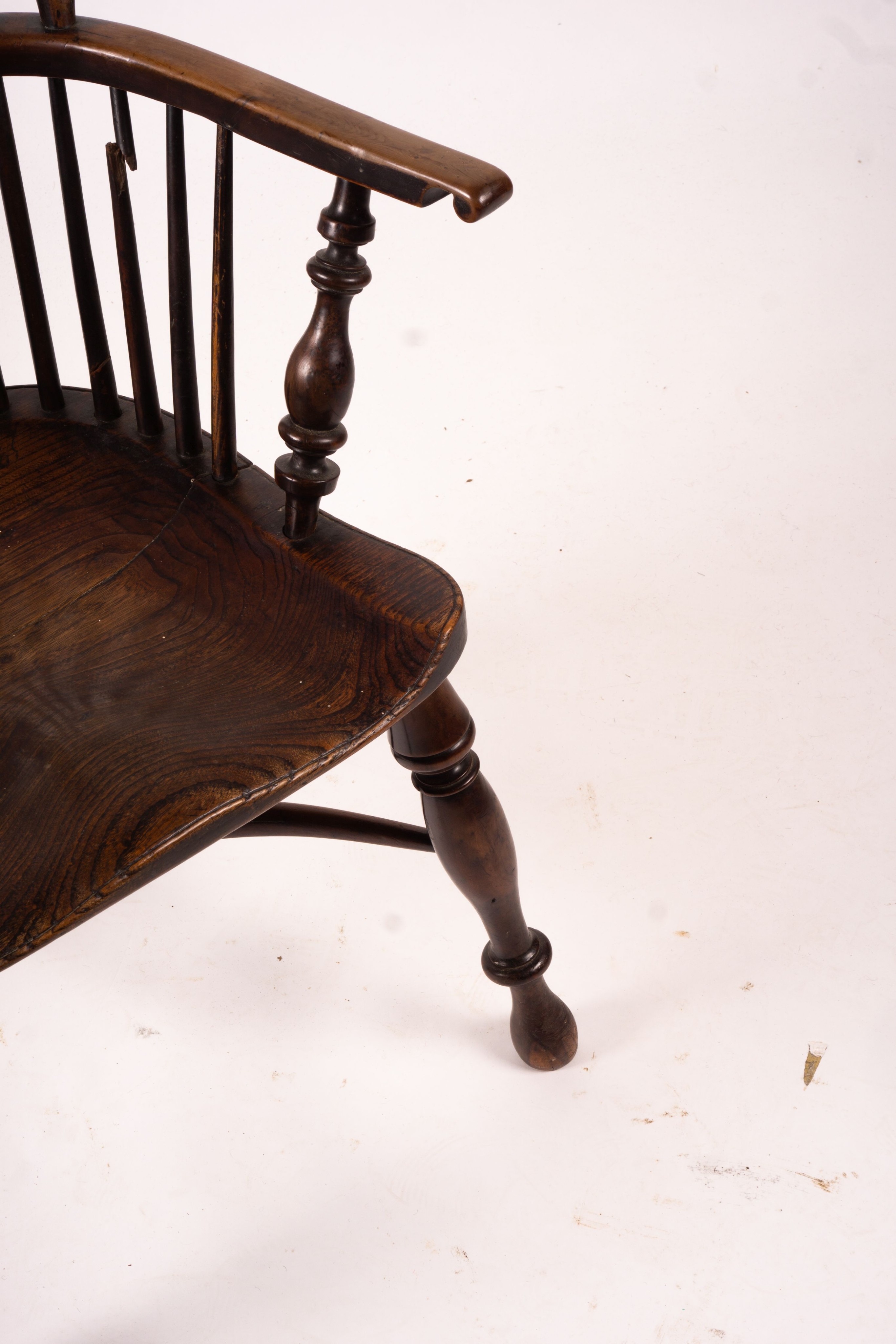 A mid 19th century yew and elm Yorkshire area Windsor armchair with saddle-seat and crinoline stretcher, width 63cm, depth 47cm, height 110cm